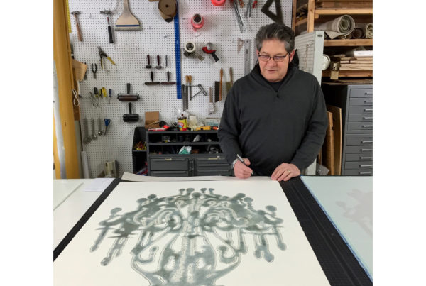 Gary Justis signing his chandelier monoprints at Manneken Press, 2016