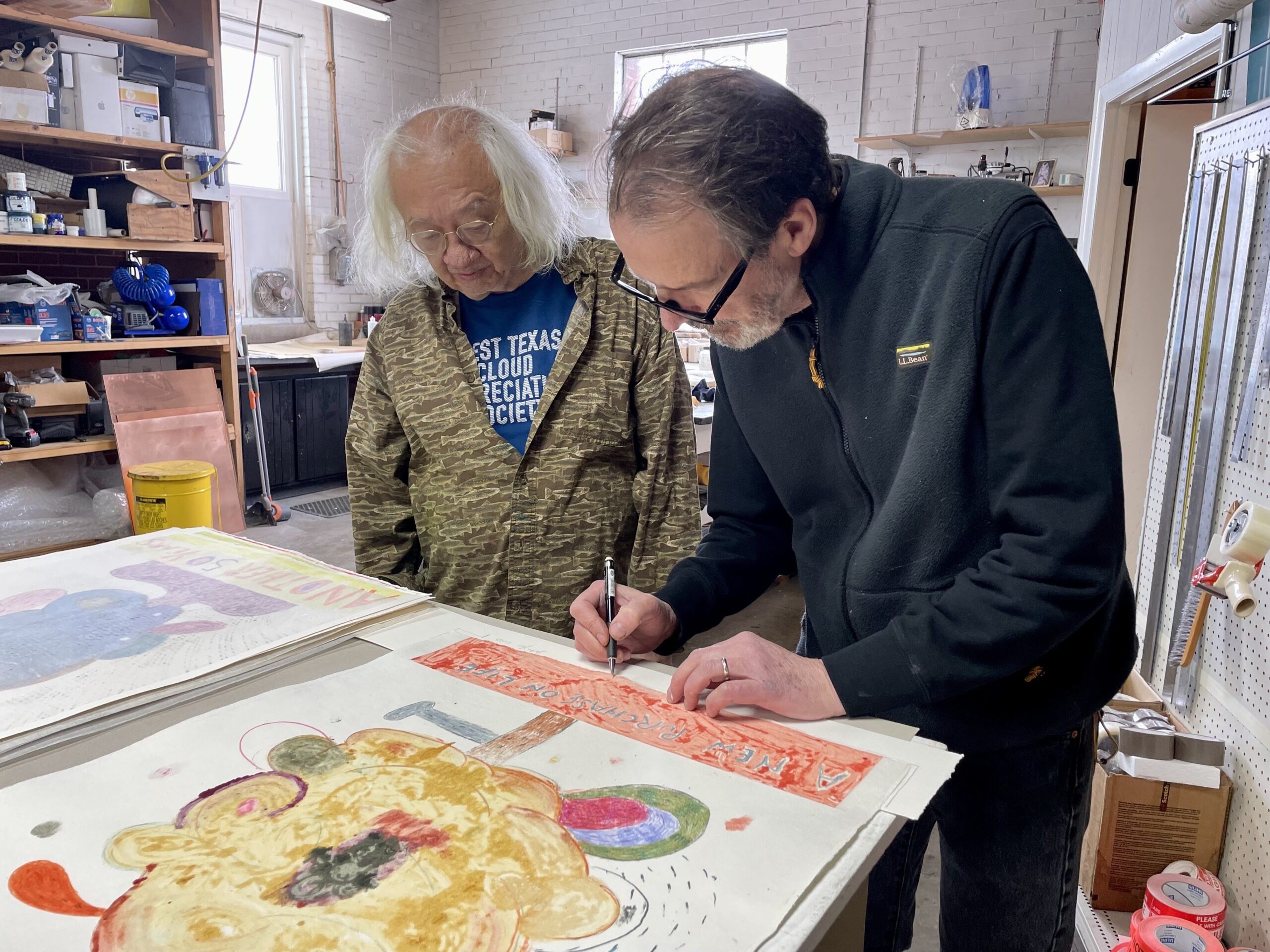 Richard Hull and John Yau signing prints at Manneken Press.